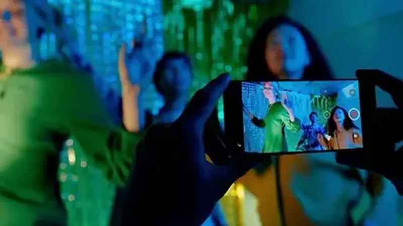 Friends recording a dance video with a phone